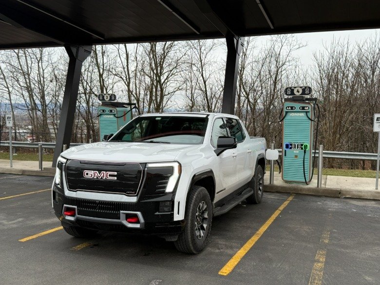 2026 GMC Sierra EV AT4 Refines Heavy Electric Truck Lineup With Targeted Upgrades 2 2026 GMC Sierra EV AT4 Max Range at a charging station