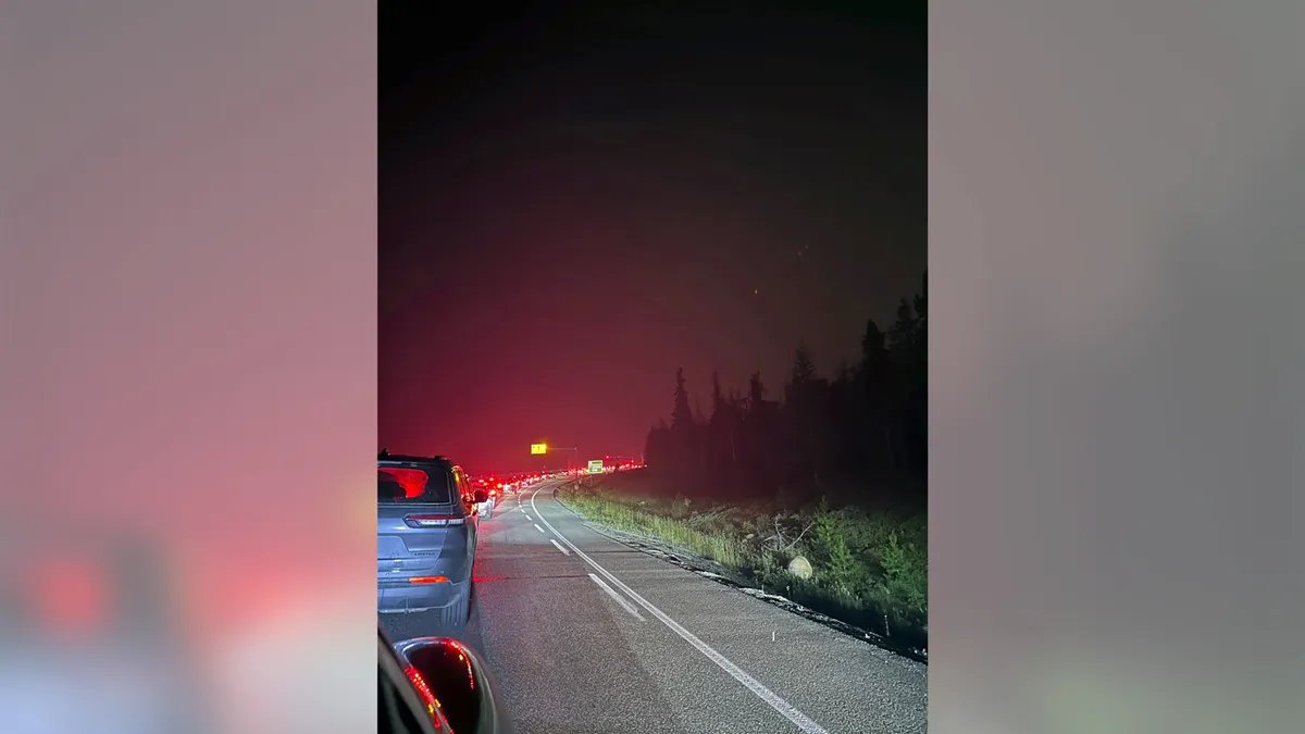 Trump Threatens Tariffs on Canada Over Wildfire Smoke, Sparking Bilateral Clash Over Forest Management 4 Cars clog the roadway in the early morning hours of July 23, 2024, as they attempt to flee wildfire that has spread through Canada's Jasper National Park.
