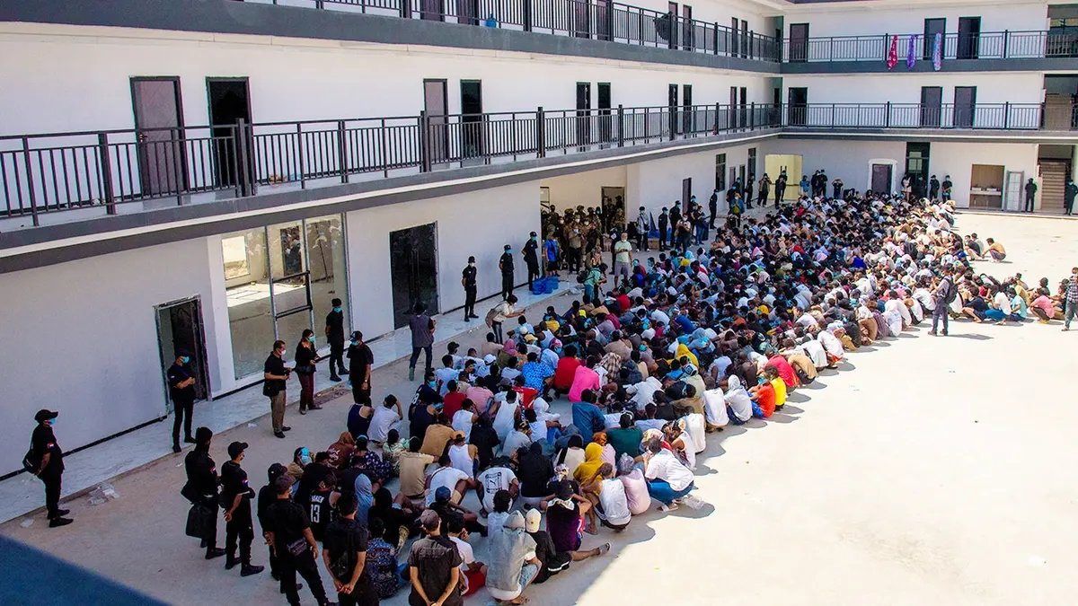Scam center victims wait in a compound in Myanmar