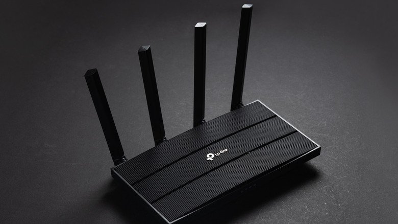 FCC Hardline Ban on Foreign Wi-Fi Routers Stalls Amid Supply Chain Realities 2 A black TP-Link router sits upon a black table.