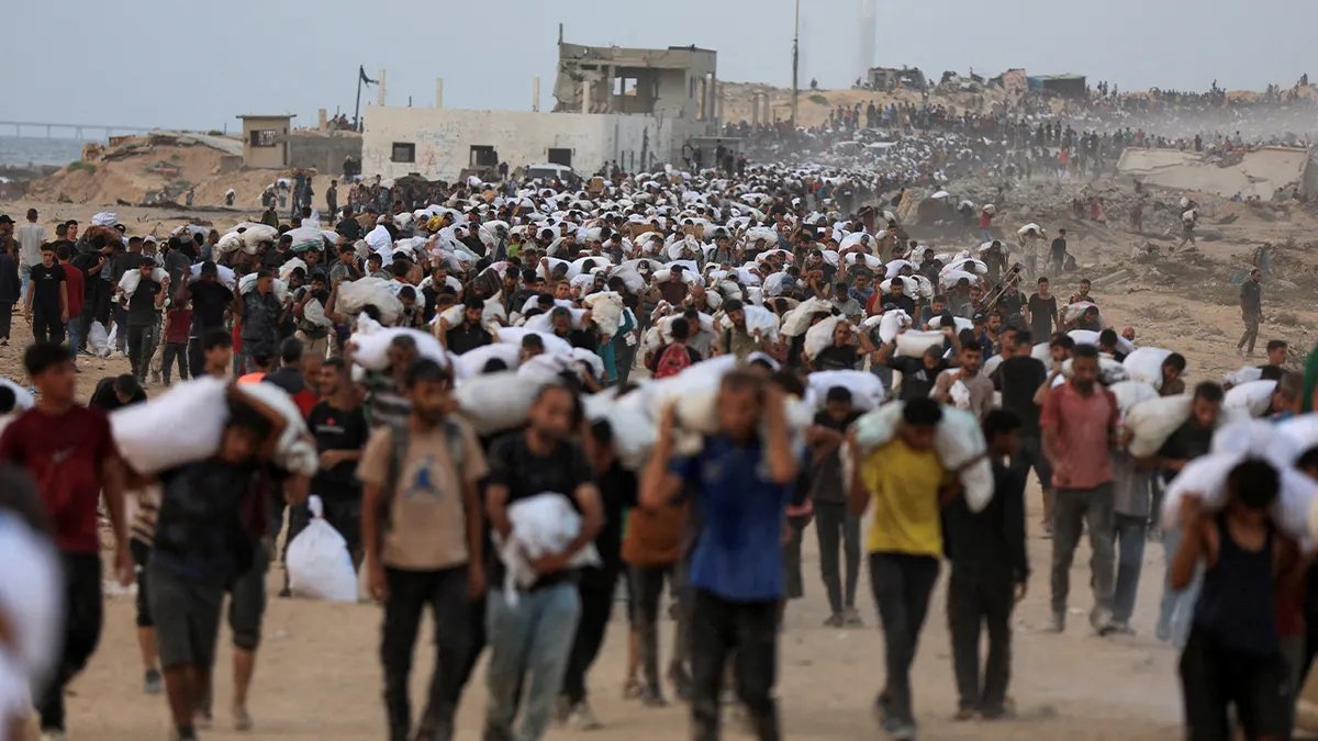 State Department Says UNICEF Report Refutes Gaza Starvation Allegations Against Israel 3 Palestinians carry aid supplies, that entered Gaza on trucks through Israel, in Beit Lahia, in the northern Gaza Strip July 29, 2025.