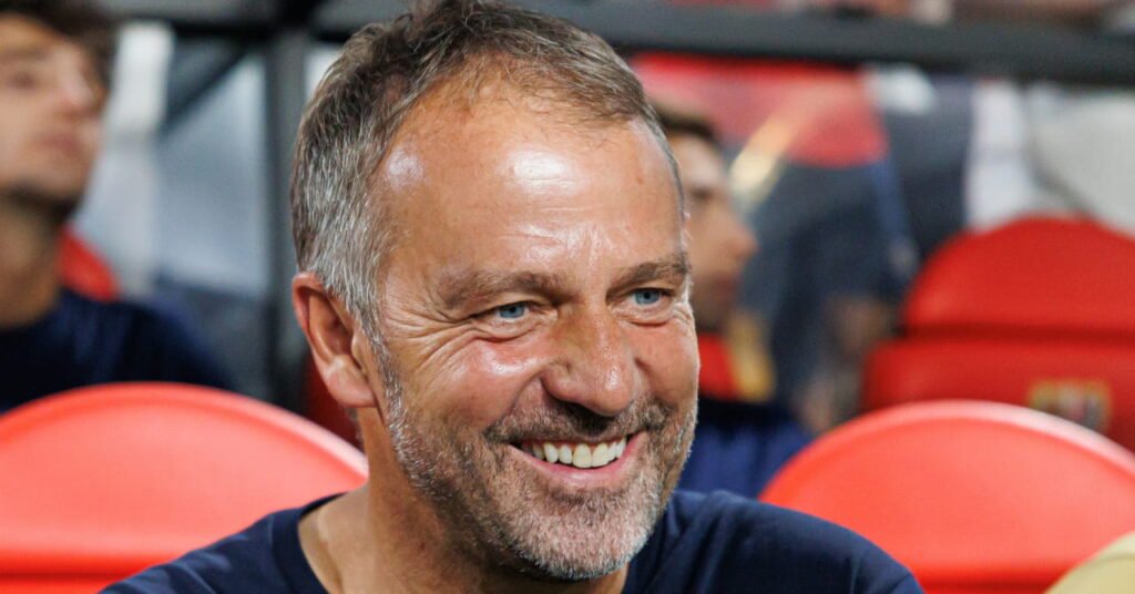 Hansi Flick Reshapes Barcelona Attack as Marcus Rashford Departs and Youngster Hamza Abdelkarim Shines 2 Football manager Hansi Flick looking to his left on a red seat in a stadium in his role as manager of La Liga side Barcelona Football Club