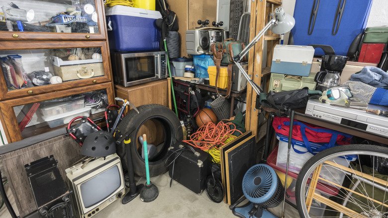 Uninsulated Garages Present Severe Degradation Risks for Stored Electronics, Building Codes Show 2 Cluttered storage area featuring a variety of equipment, tools, and vintage electronics.