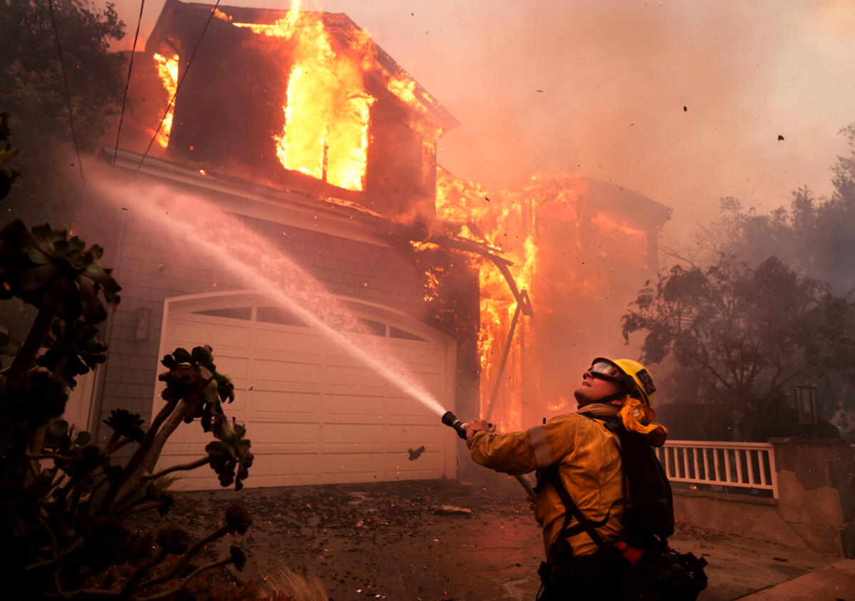 Firefighters battle a house fire.