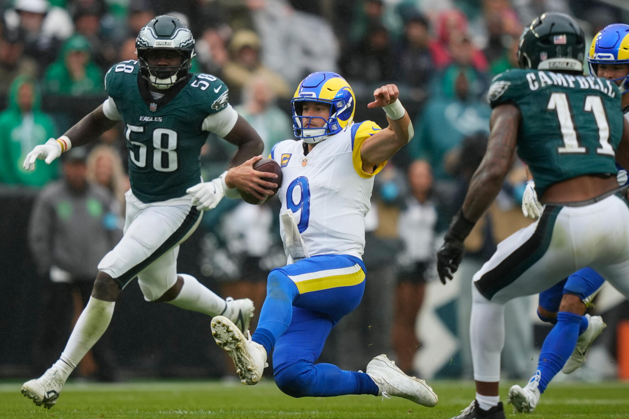Rams quarterback Matthew Stafford slides after running the ball against the Eagles on Sunday.