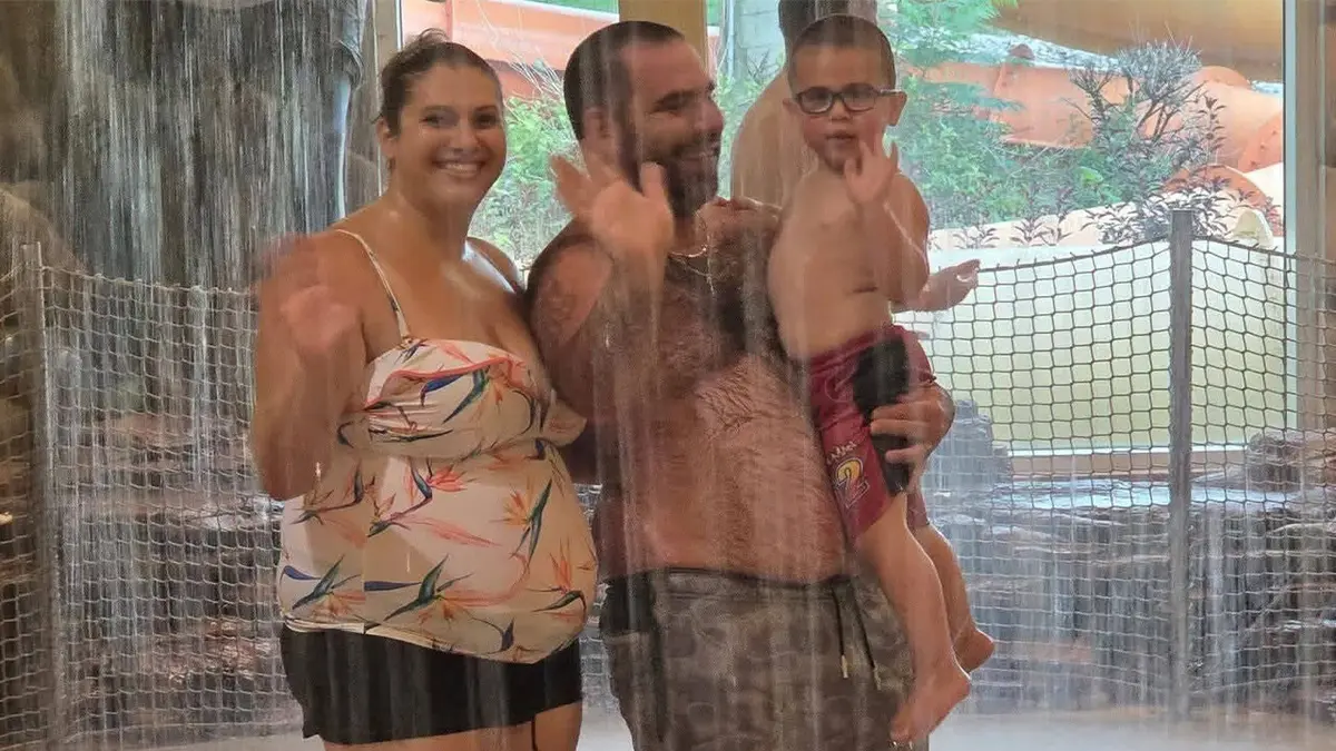 image shows family in pool