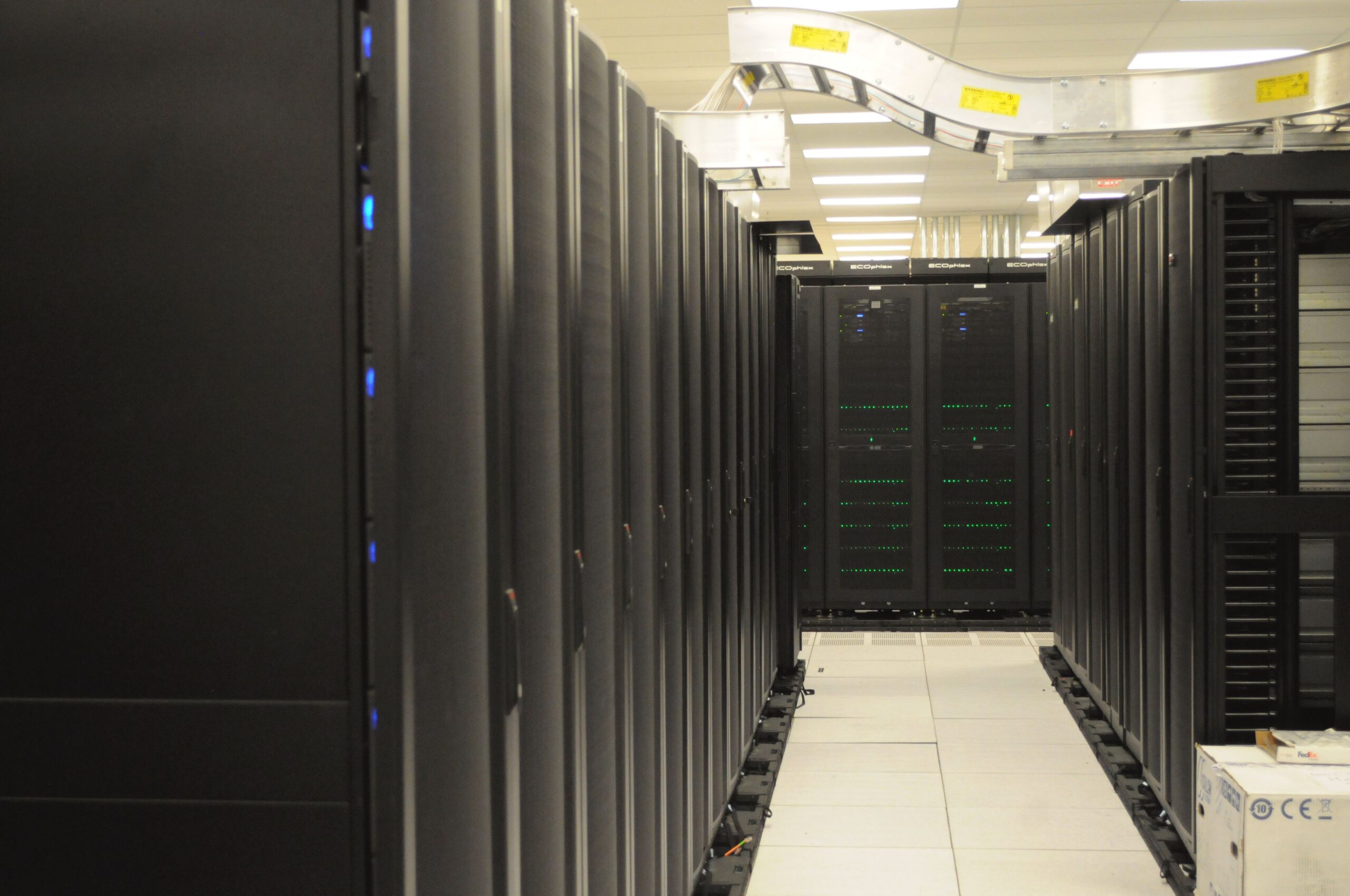 Rows of server racks in a data center aisle