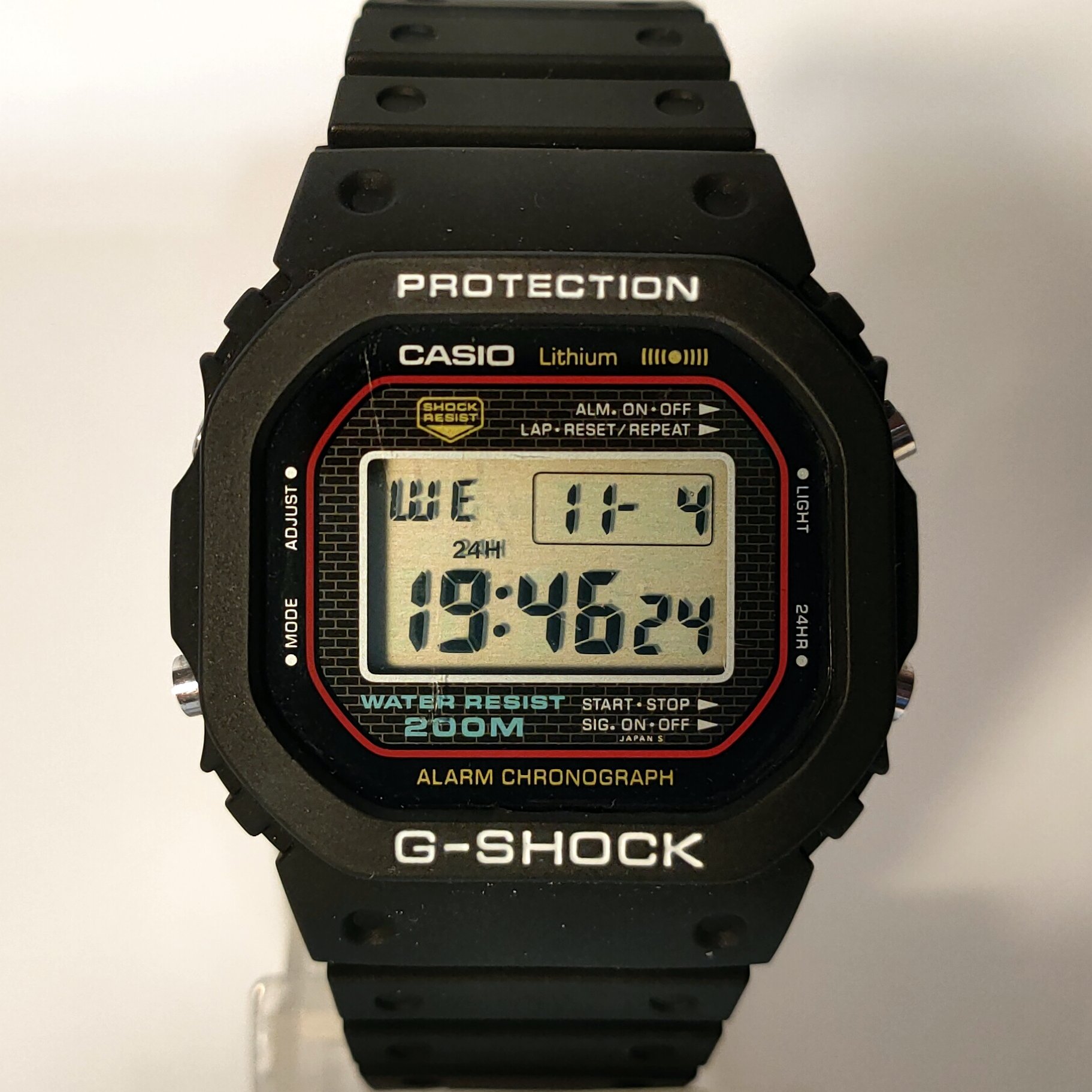 The original 1983 Casio G-Shock DW-5000C with a square black resin case and digital display