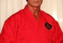 Richard Norton in 2014, wearing a red martial arts gi