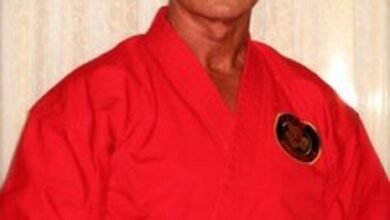 Richard Norton in 2014, wearing a red martial arts gi