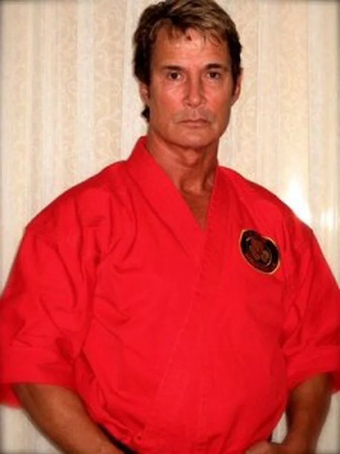 Richard Norton in 2014, wearing a red martial arts gi