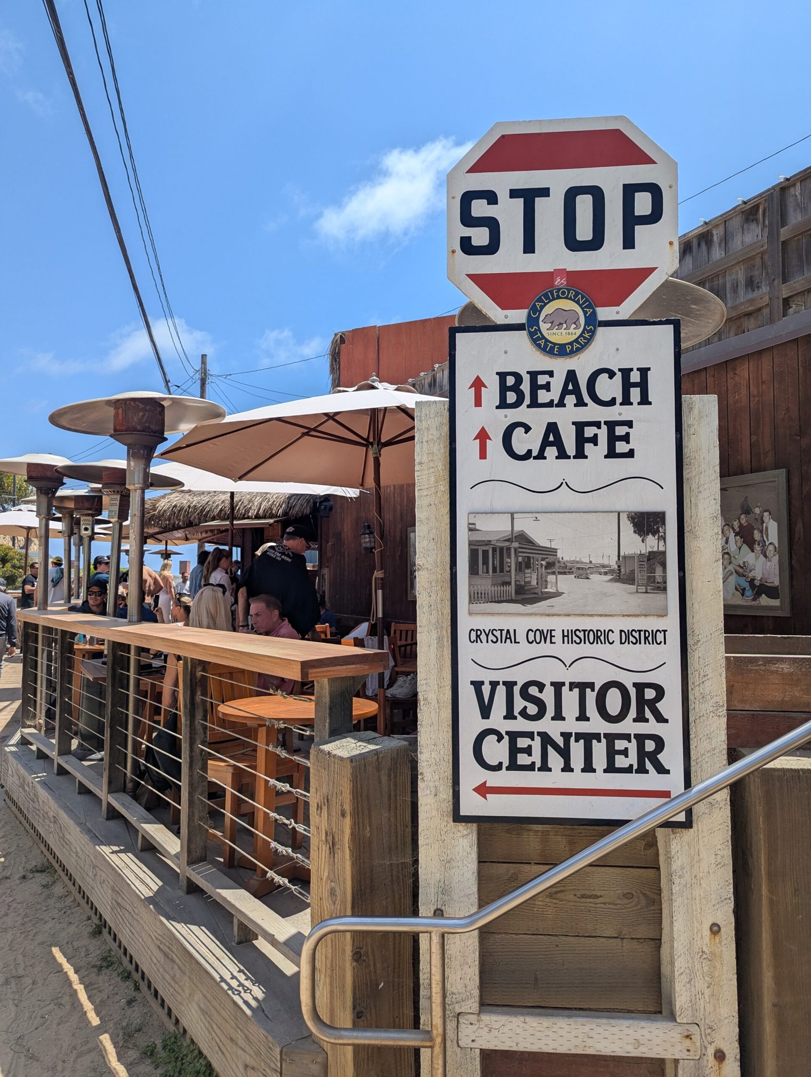 Crystal Cove Historic District sign and the Beachcomber cafe deck, Crystal Cove State Park, photographed 25 May 2025