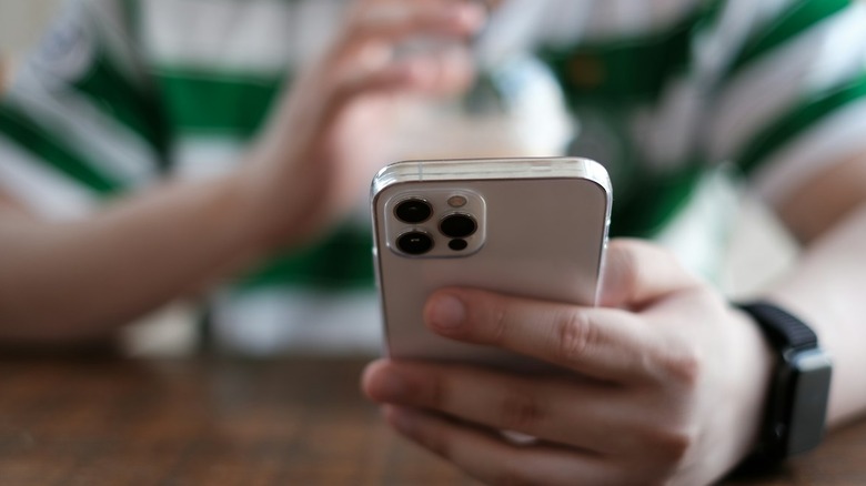 A teenager using an iPhone.