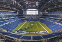 Lucas Oil Stadium bowl in Indianapolis with empty blue seats and the field below