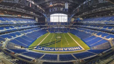 Lucas Oil Stadium bowl in Indianapolis with empty blue seats and the field below