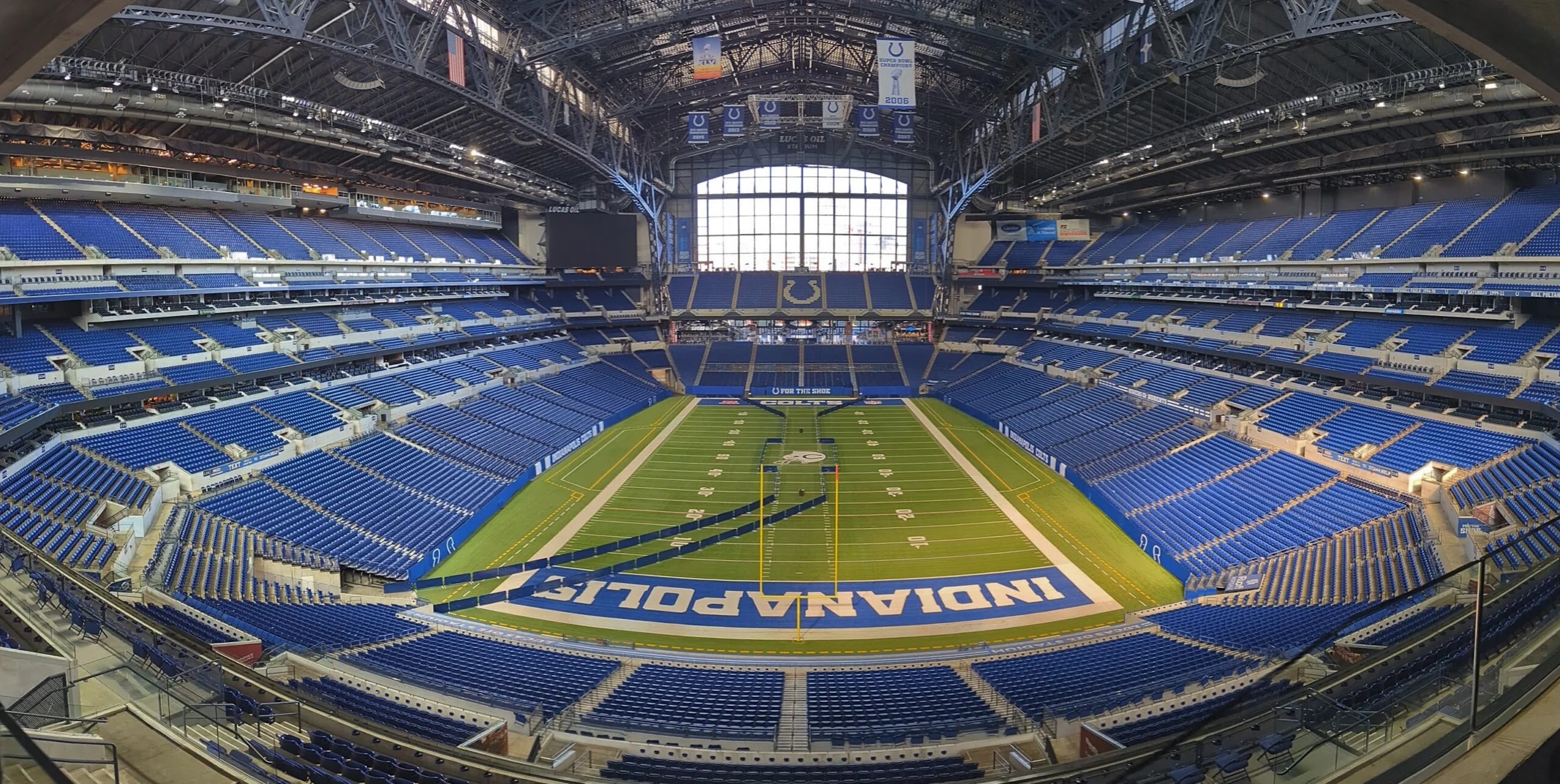 Lucas Oil Stadium bowl in Indianapolis with empty blue seats and the field below