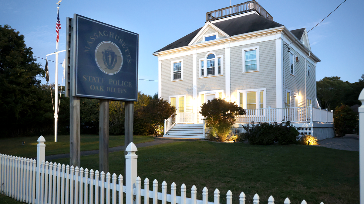 The Martha's Vineyard State Police barracks at dusk, with lights on
