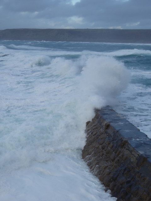 Waves crashing over a breakwater