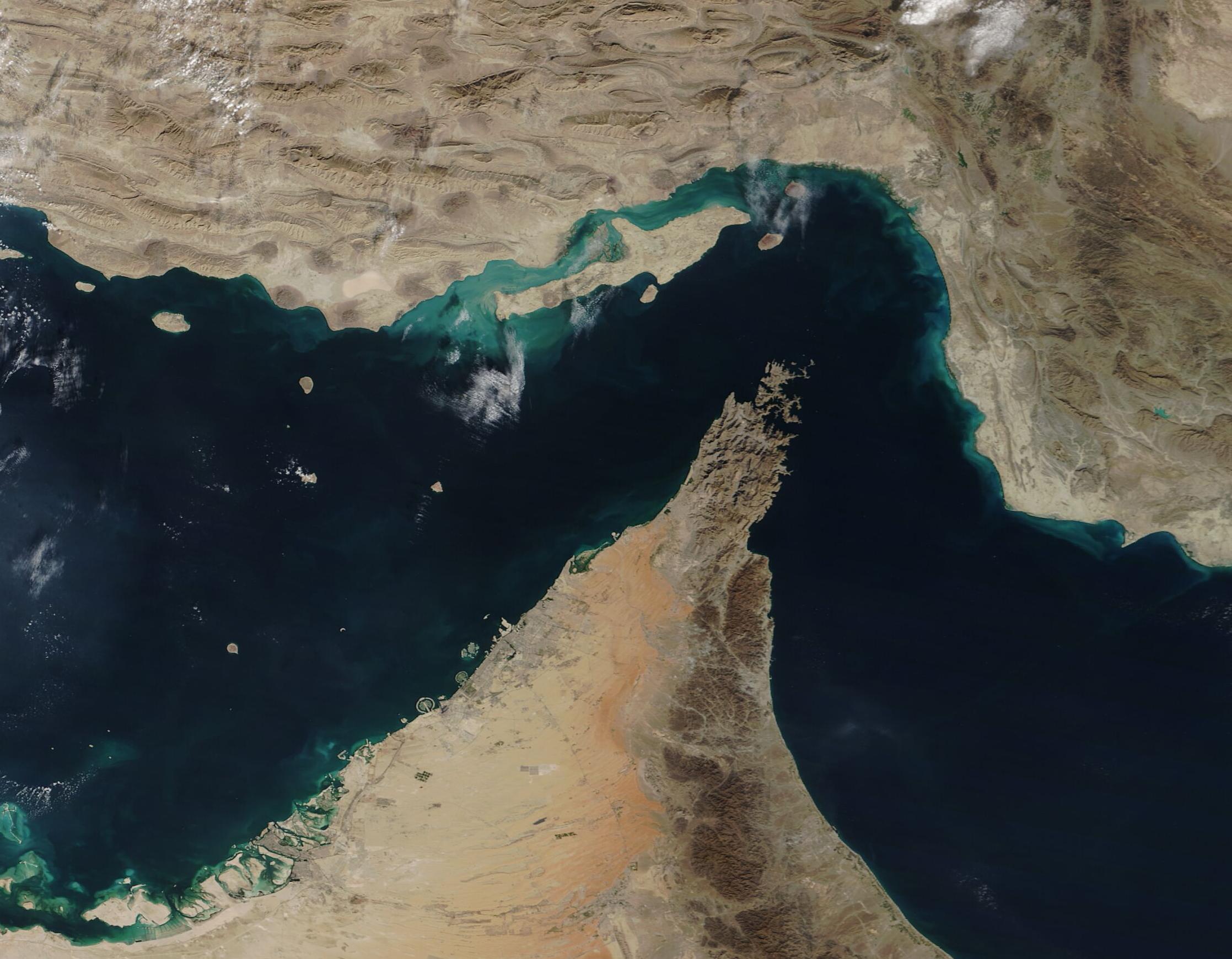 Satellite view of the Strait of Hormuz, the 21-mile-wide waterway at the center of every clock in this war